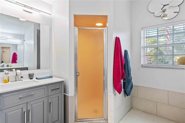 bathroom featuring walk in shower and vanity