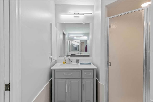 bathroom with walk in shower and vanity