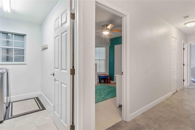 hall featuring light tile patterned floors