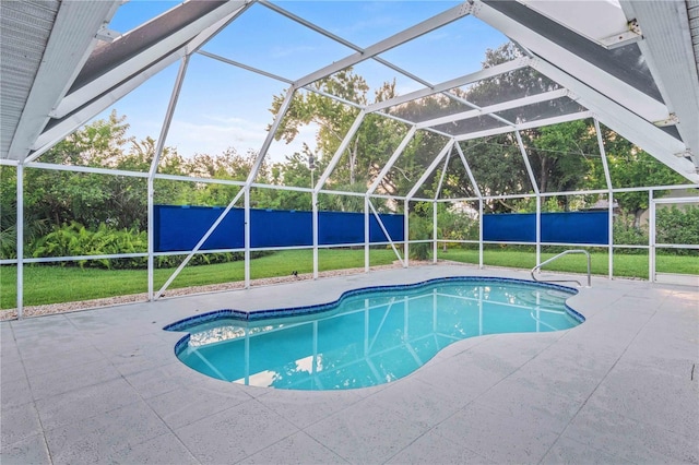 view of pool with a patio area and a lanai