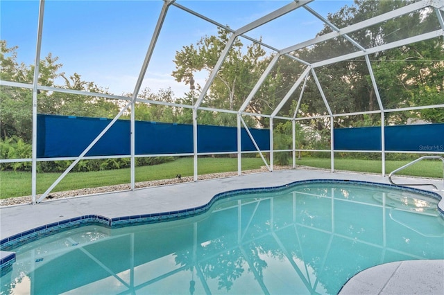 view of swimming pool featuring a lanai