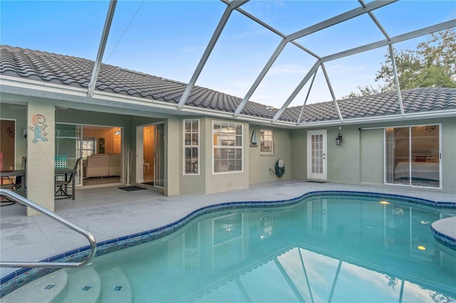 view of pool featuring a patio area and glass enclosure