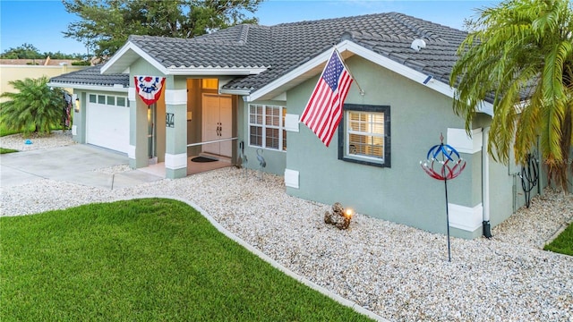 view of front of property with a garage and a front lawn