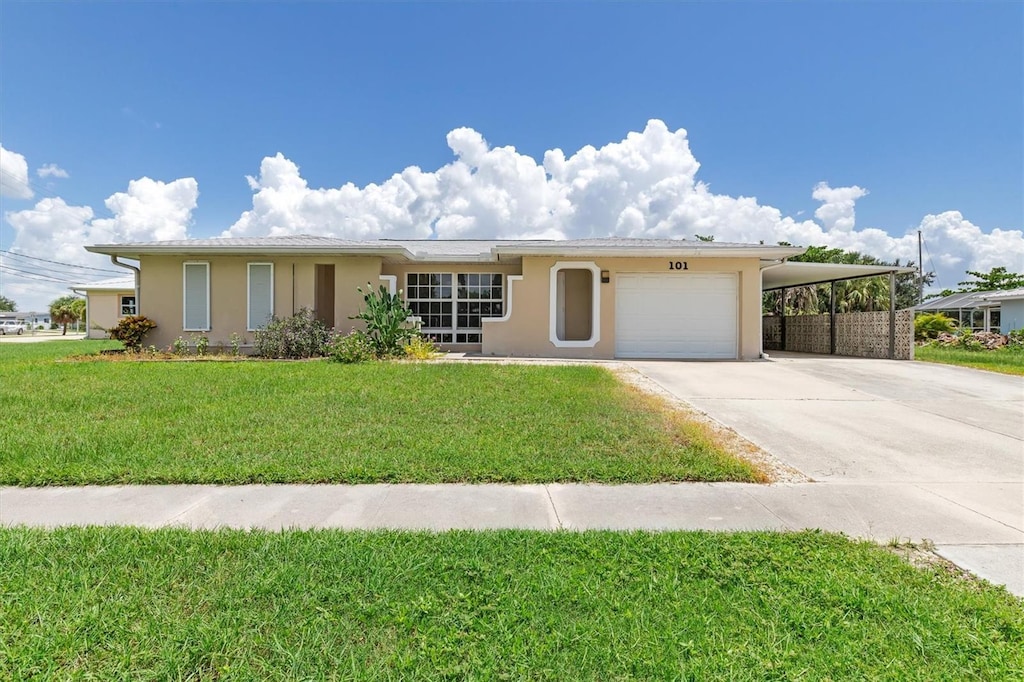 ranch-style home with a carport, a garage, and a front yard