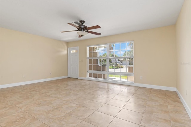 empty room with light tile patterned floors and ceiling fan