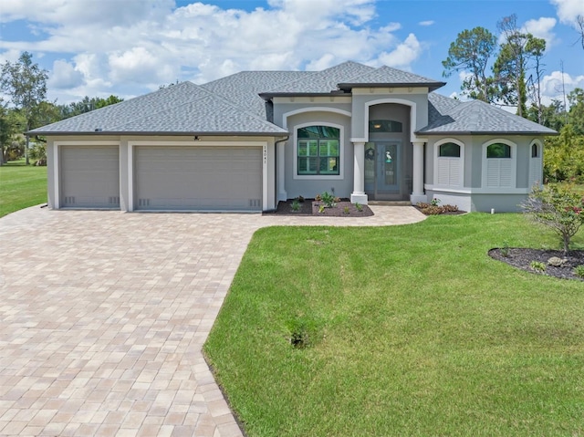 view of front of property with a garage and a front yard