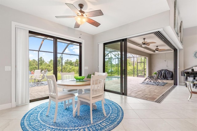 dining area featuring tile patterned flooring and ceiling fan