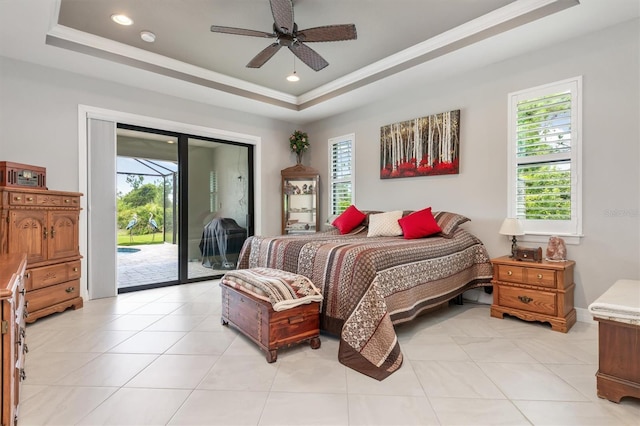 tiled bedroom featuring ornamental molding, access to outside, ceiling fan, and a tray ceiling