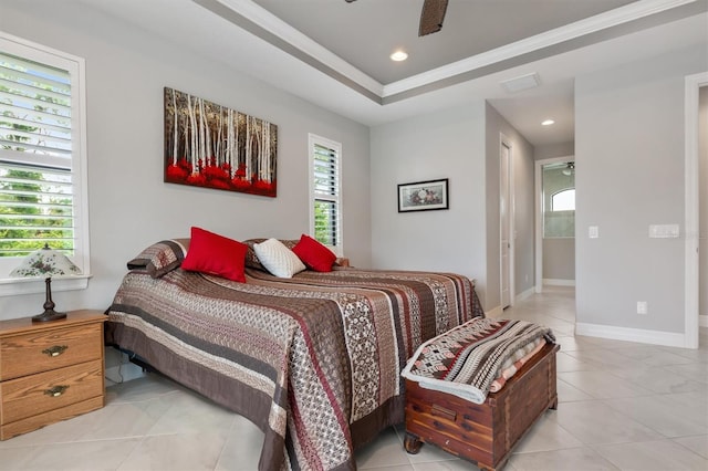 bedroom featuring crown molding, a tray ceiling, and ceiling fan