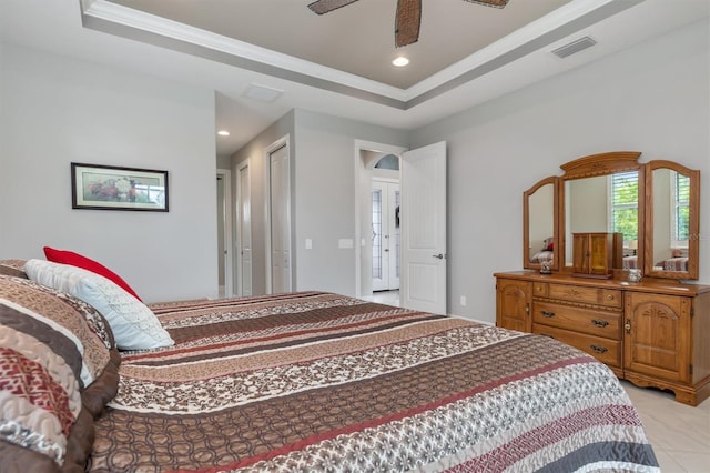 bedroom featuring crown molding, a tray ceiling, and ceiling fan