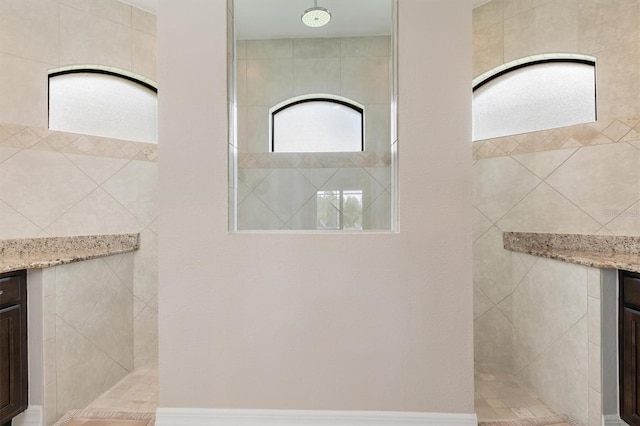 bathroom with vanity and tiled shower