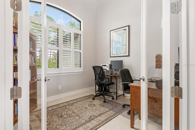 office space with light tile patterned flooring and french doors