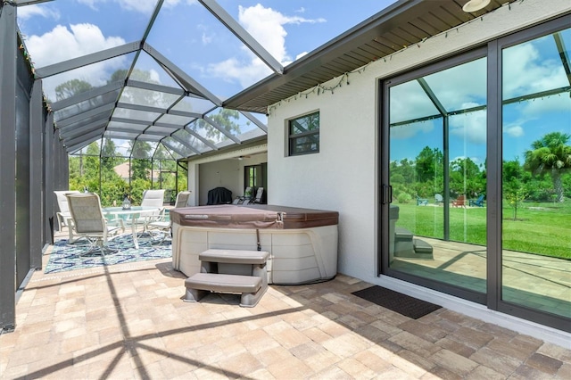 view of patio featuring a hot tub and a lanai