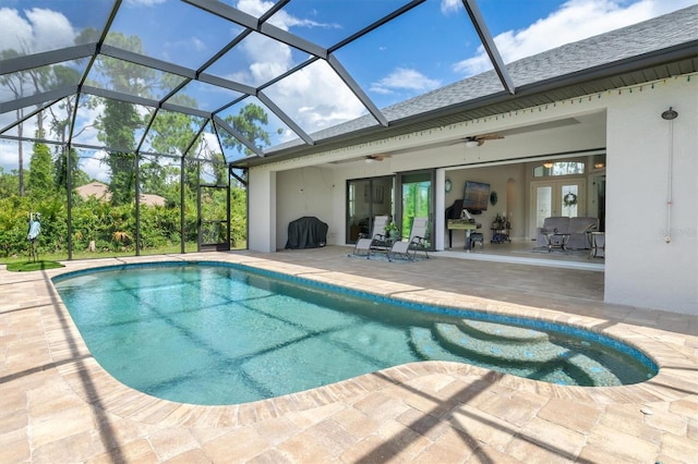 view of pool featuring french doors, ceiling fan, a patio area, and glass enclosure