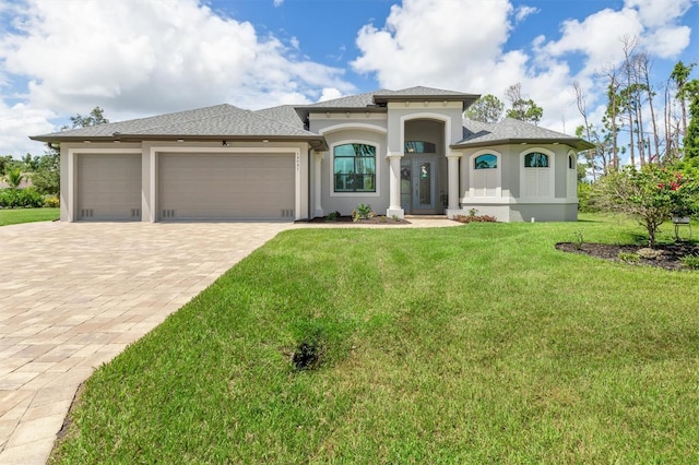 view of front of property featuring a garage and a front lawn