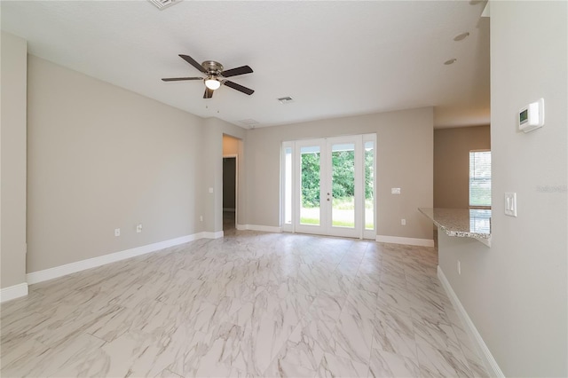 unfurnished room featuring french doors and ceiling fan