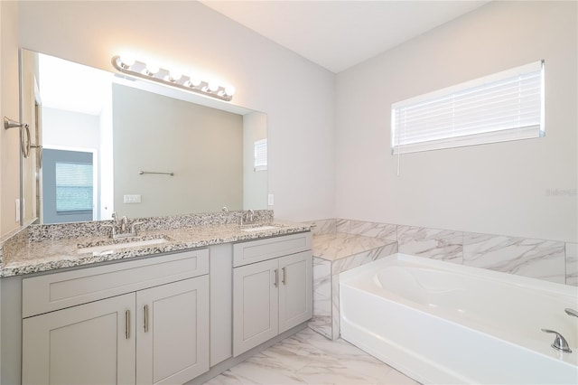 bathroom with vanity and a tub