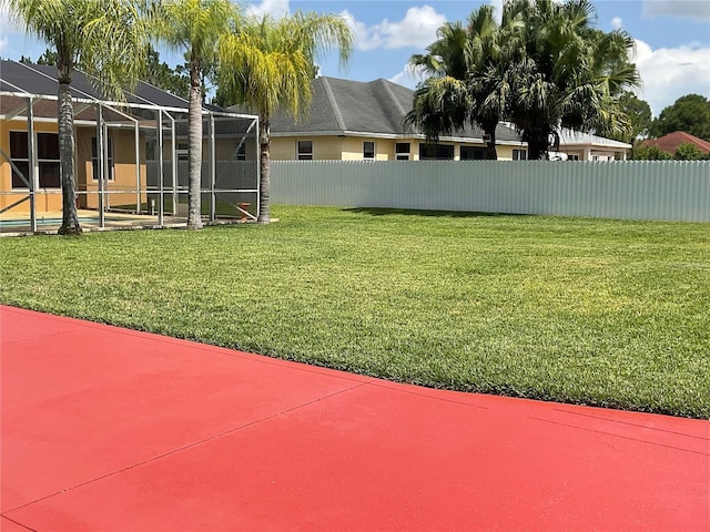 view of yard with glass enclosure