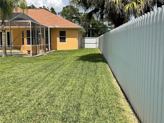 view of yard with a lanai and a pool