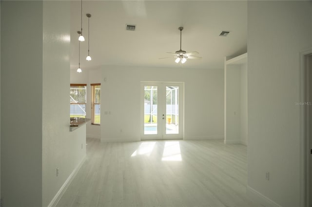 unfurnished room with french doors, light hardwood / wood-style flooring, and ceiling fan