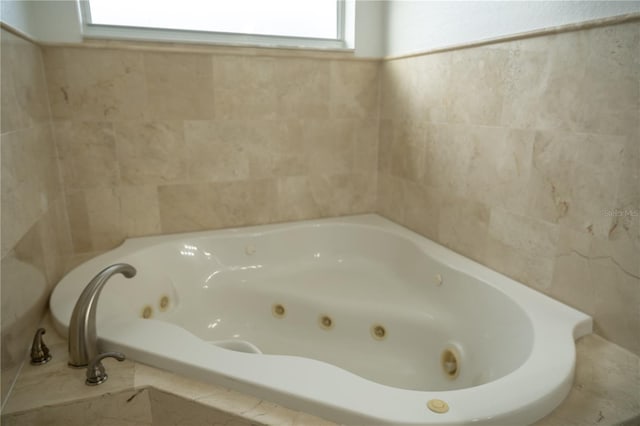 bathroom featuring tiled tub