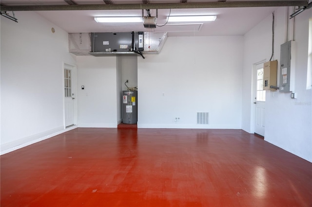 garage featuring electric panel, water heater, and a garage door opener