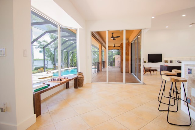 interior space with a lanai and ceiling fan