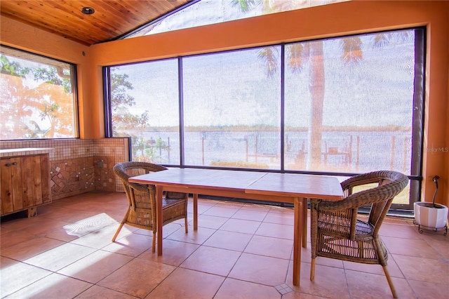 sunroom with vaulted ceiling and wood ceiling