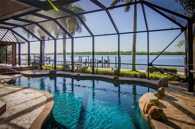 view of pool featuring a water view, a patio area, and glass enclosure