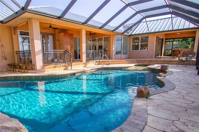 view of pool with a lanai, a patio area, and ceiling fan