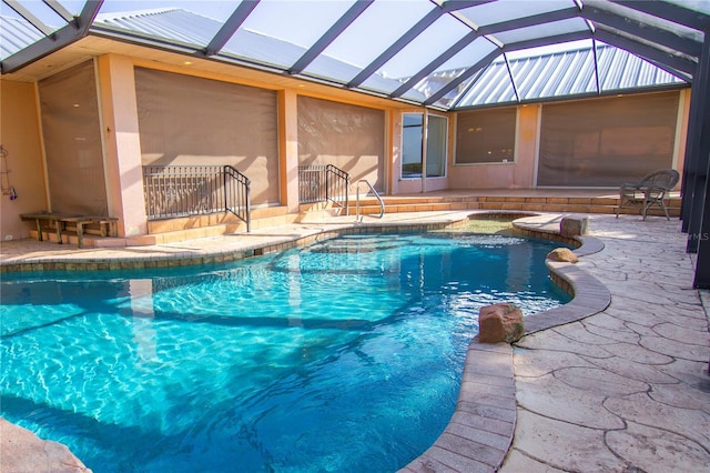 view of swimming pool featuring a patio and glass enclosure