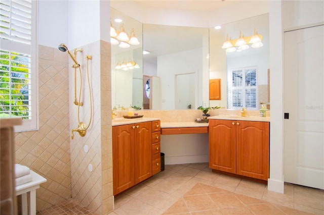 bathroom featuring vanity, tile patterned floors, and a tile shower