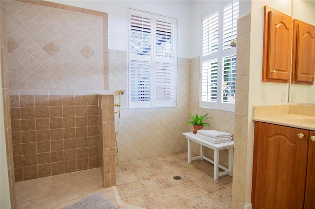 bathroom with vanity, tile patterned floors, and a tile shower