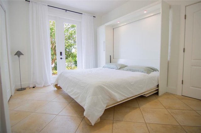 tiled bedroom featuring access to exterior