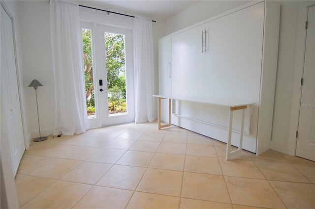 doorway with light tile patterned floors