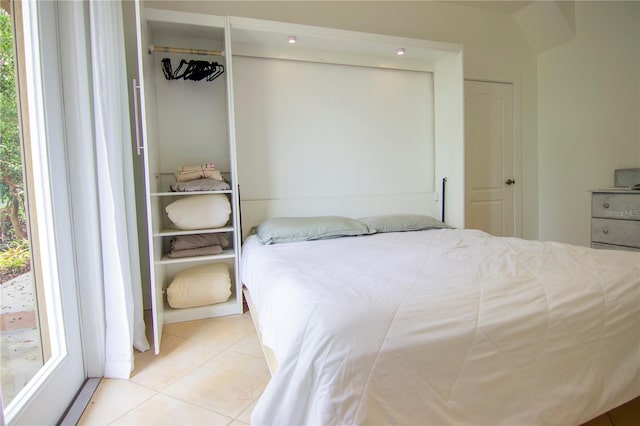 tiled bedroom with a closet