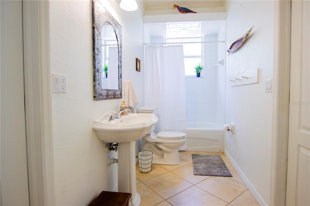 bathroom with tile patterned floors, toilet, and shower / bath combo with shower curtain