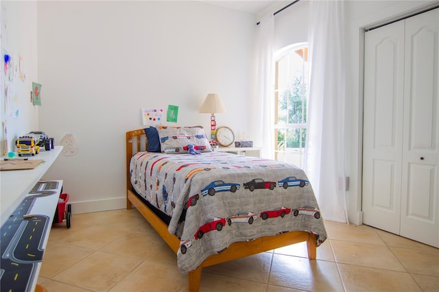 tiled bedroom with a closet