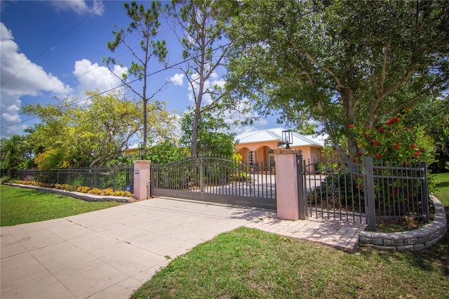 view of gate featuring a lawn