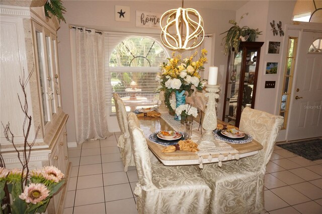 dining space with light tile patterned floors and a notable chandelier