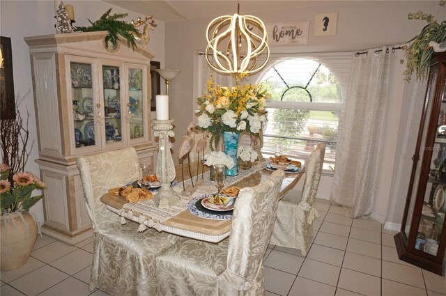 tiled dining space with a notable chandelier