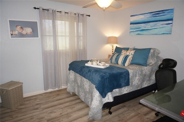 bedroom featuring ceiling fan and wood-type flooring