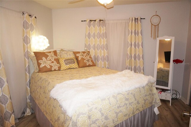 bedroom featuring ceiling fan and dark hardwood / wood-style floors