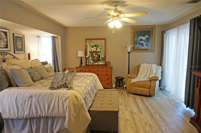 bedroom with light hardwood / wood-style floors and ceiling fan