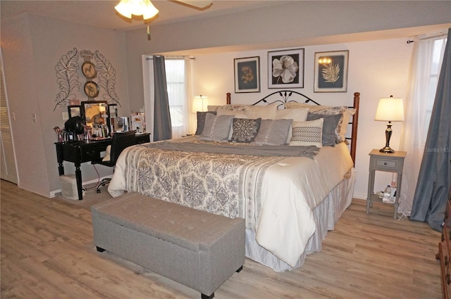 bedroom with ceiling fan and hardwood / wood-style flooring