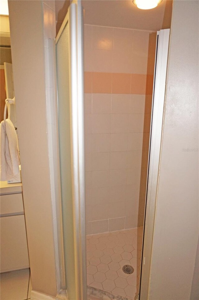 bathroom with tile patterned floors, vanity, and walk in shower