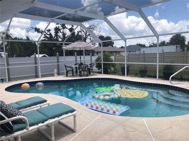 view of pool featuring a lanai and a patio