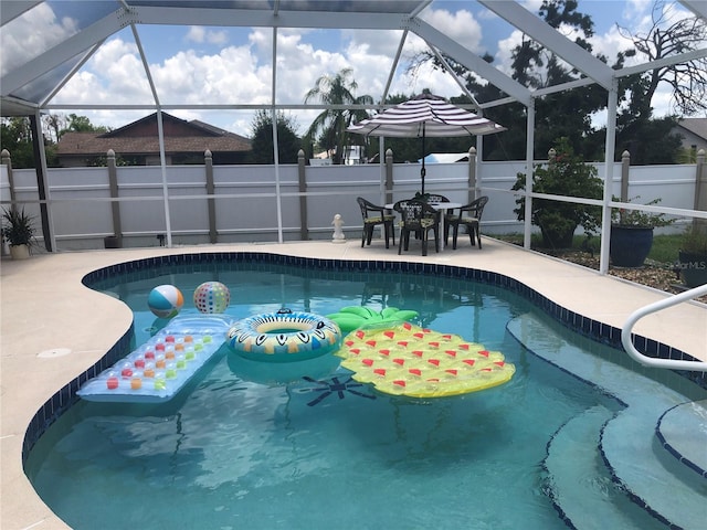 view of pool featuring a patio area and glass enclosure