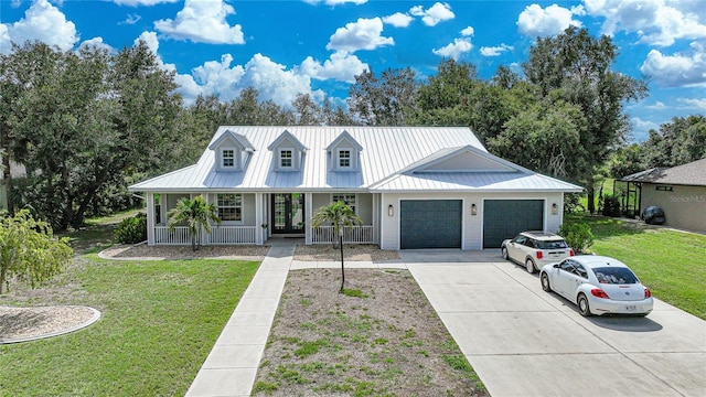 view of front of home with a front yard, a porch, and a garage