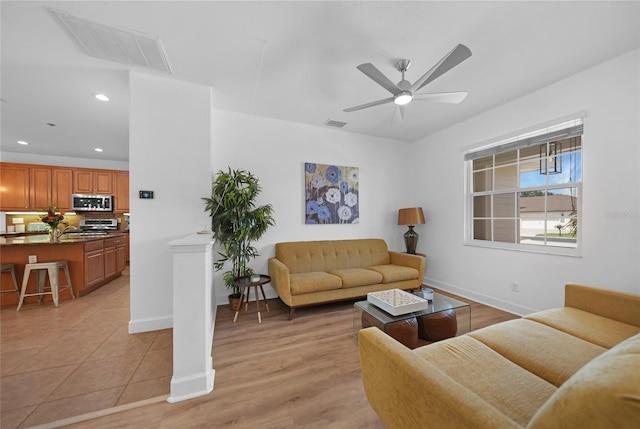 living room with ceiling fan and light tile patterned floors